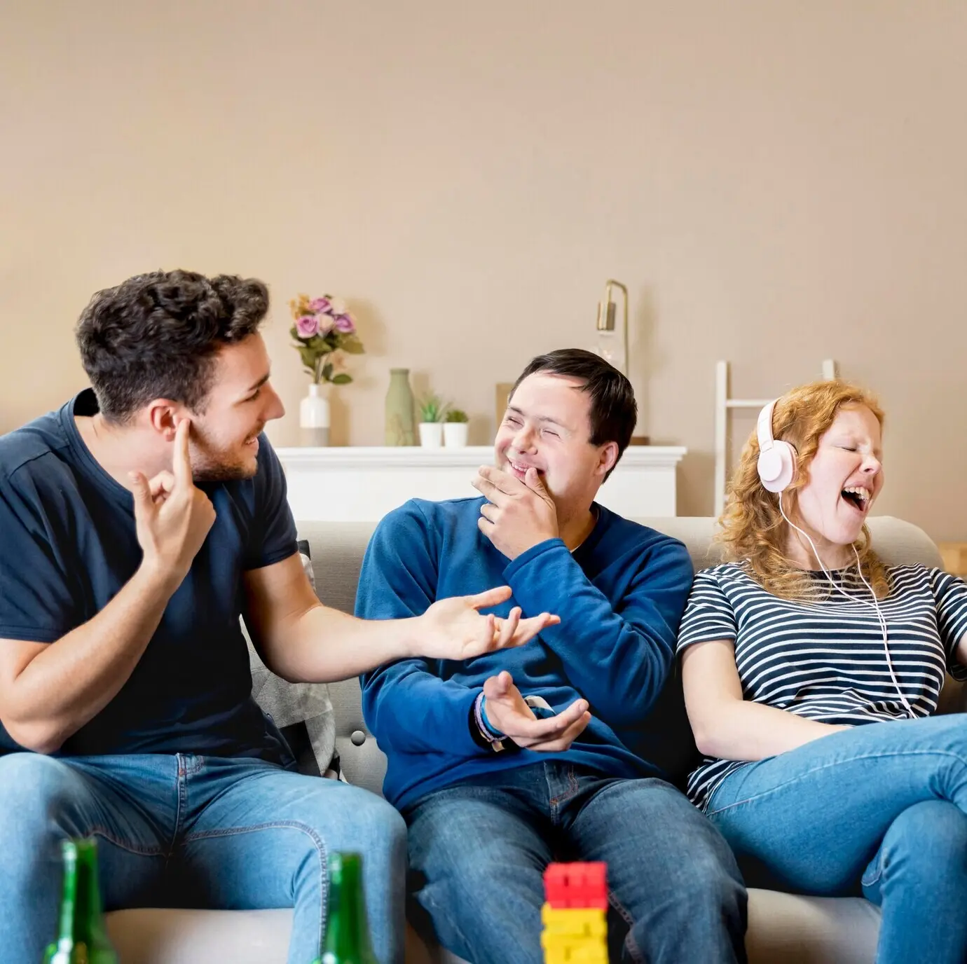 Frontal view of men laughing at a woman who is singing.